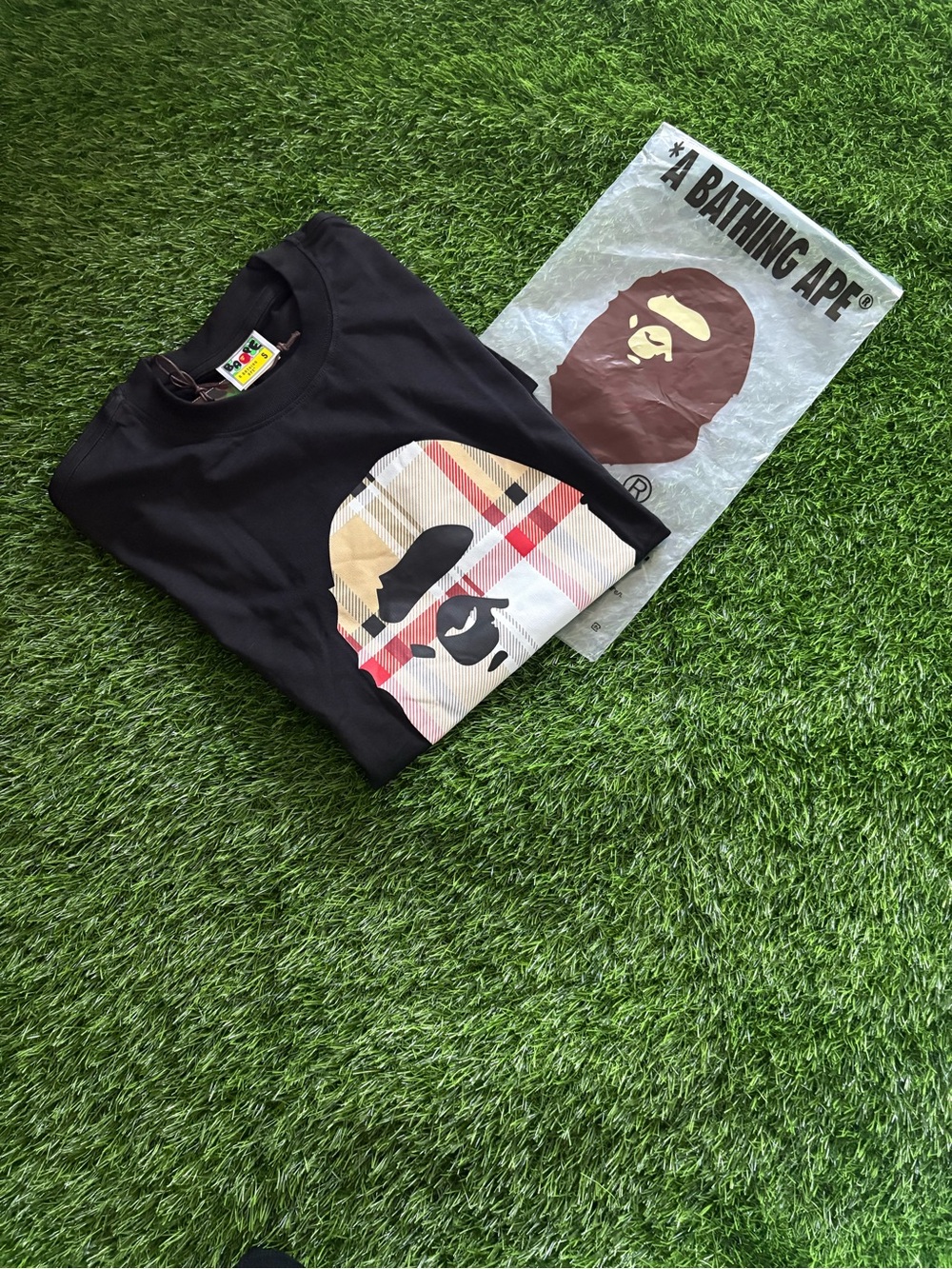 A Bathing Ape Black Short-Sleeve Tee with Beige Plaid Ape Head